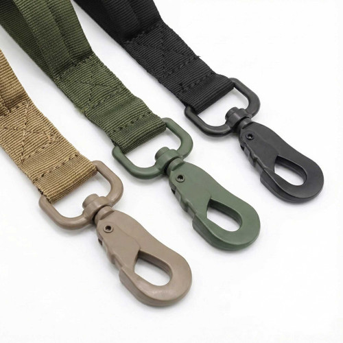 Close-up of heavy-duty zinc alloy swivel clips on Coyote Tan, OD Green, and Black tactical leashes. Shows reinforced stitching and 360-degree rotating metal hardware