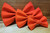 Solid orange handmade pet bow tie with double elastic loops for dog collar attachment