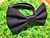 Solid black handmade pet bow tie with double elastic loops for dog collar attachment