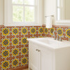 Decorative 4x4 Mexican tiles with yellow, cobalt and terracotta accents decorating eclectic style bathroom walls