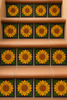 Terracotta stairs decorated with sunflower relief tiles on each riser