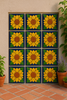 Outdoor wall decorated with sunflower relief tiles and terracotta floor.
