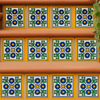 Stair risers decorated with "Colonial Sun" Talavera tiles featuring blue flowers, green leaves, and yellow accents.