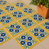 Outdoor floor with "Colonial Sun" Talavera tiles in yellow, blue, and green, next to a terracotta planter.