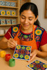 Fiesta Garden being hand-painted by a smiling artisan in a traditional workshop Fiesta Garden being hand-painted by a smiling artisan in a traditional workshop