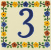 Hand painted Talavera House Number Tile Three with a vivid blue digit enclosed by a lively decorative pattern on a cream surface.