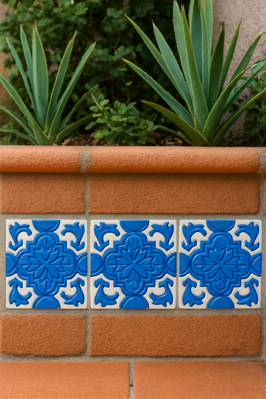 Blue Luciana relief tiles decorating a terracotta garden border