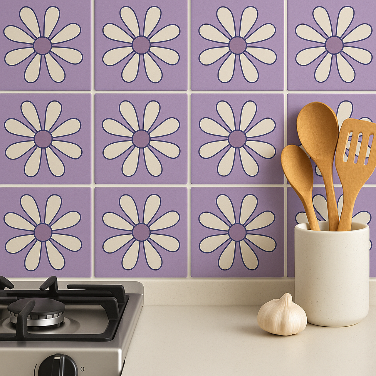 Lavender daisy relief tile backsplash behind a gas cooktop and wooden utensils.