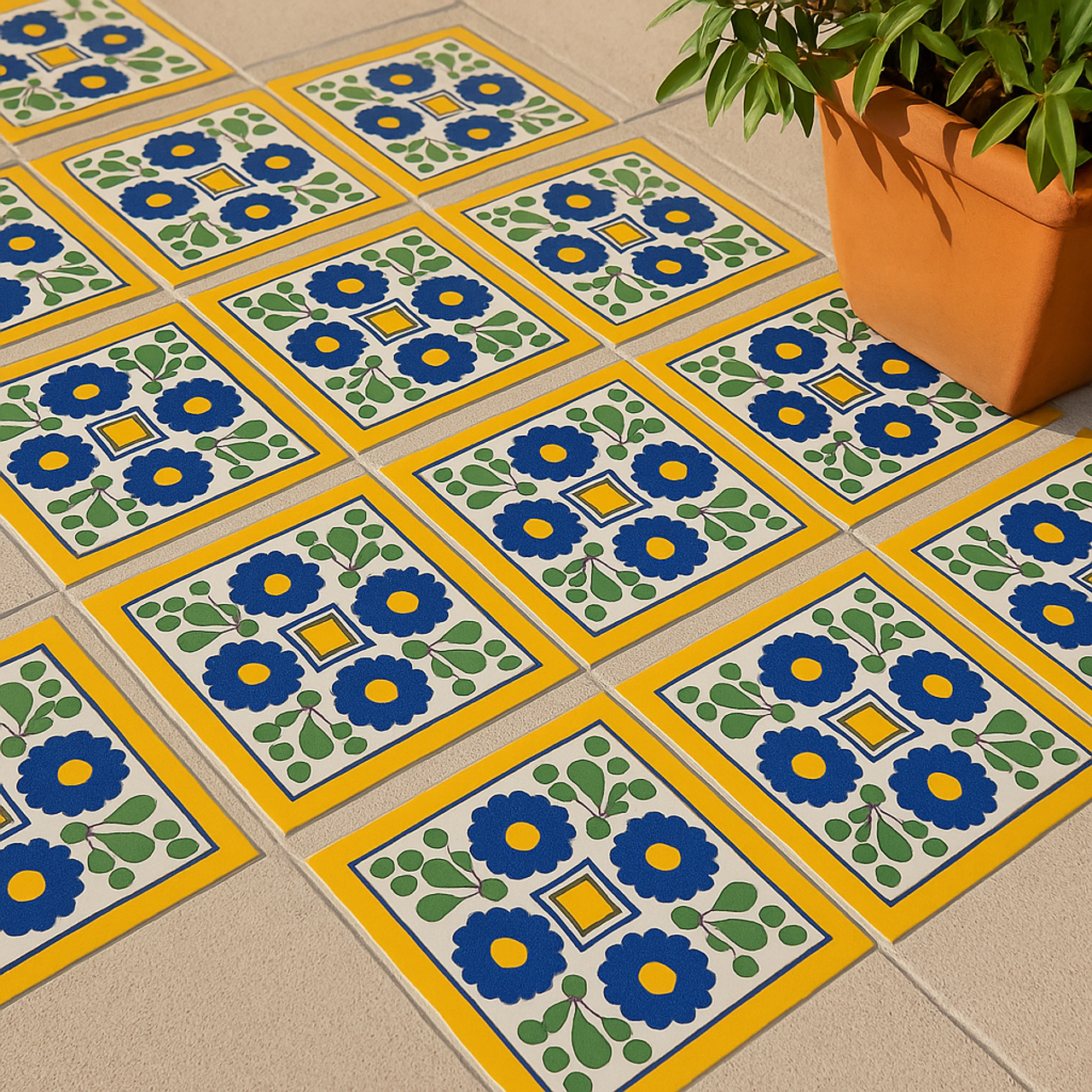 Outdoor floor with "Colonial Sun" Talavera tiles in yellow, blue, and green, next to a terracotta planter.