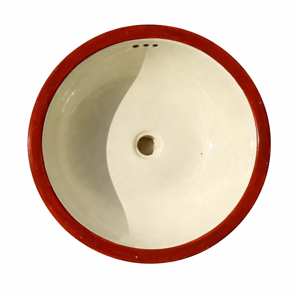 Round Mexican ceramic bathroom sink with cream glazed interior, terracotta red rim and overflow holes