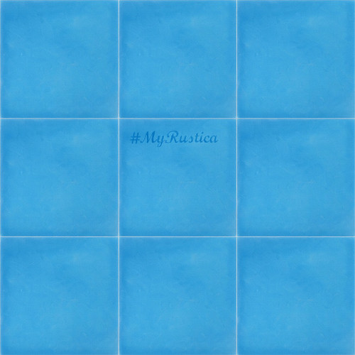 detail view of mexican tiles hand painted in solid light blue color