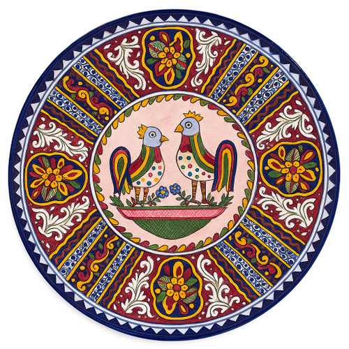 Birds Talavera Plate featuring two colorful birds hand-painted on a rustic pink background with ornate red and blue border.