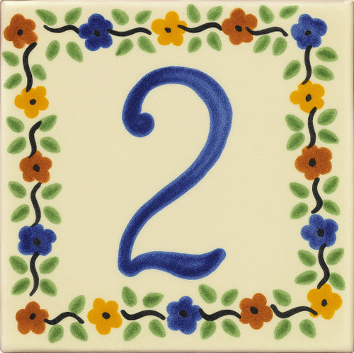 Talavera House Number Tile Two decorated with a lively multicolor border of small shapes and leafy details on a cream background.