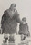 This image is of Two Hame from the Toon -  an original pencil drawing by Alexander Millar. It shows an adult woman, perhaps the mother, and a child walking away from the viewer and carrying shopping bags. The woman is dressed in a tartan headscarf and a woolly coat and heavy boots. She has her right hand on the shoulder of the child. He is wearing  what looks like a duffel coat and a balaclava. It is a black-and-white pencil drawing..