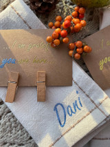 Image of a tan napkin using Cornflower Blue Sparkle to spell “Dani” alongside brown cardstock with Gold Star and Cornflower Blue Sparkle reading “… I am grateful you are here …”