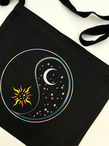 Image of a black bag with a Yin and Yang design using Twinkle rainbow for the circle, black, white, pink for the moon half, red, orange and yellow for a sun half.