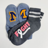 Image of light and dark gray socks, one with a University of Michigan logo using Blue Easy Puff and Yellow Easy Puff, and the other with a logo that reads "Fight" in Pink Easy Puff and incorporating a breast cancer awareness ribbon made in White Easy Puff.