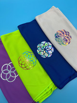 Image of four towels each with a rounded designs with varying detail created using various colors of Holographic heat transfer material.