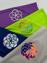 Image of four towels each with a rounded designs with varying detail created using various colors of Holographic heat transfer material.