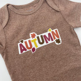 Image of a brown onsie that has a logo that reads "Autumn" made with EasyColor DirectToVinyl