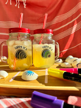 Image of two identical mason jars with red tops and straws and a logo of a “Clam” and words “Happy as a” on top using EasyPSV BlackBoard one both; one in plain black, the other “Clam” colored in using liquid chalk markers.