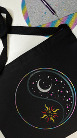 Image of a black bag with a Yin and Yang design using Twinkle rainbow for the circle, black, white, pink for the moon half, red, orange and yellow for a sun half.