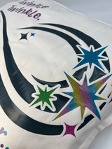 Image showing a partial view of a white pillowcase a logo that reads “Tinkle Twinkle”, above several different colored starshaped designs all connected by an organic, swirl-like shape using navy blue Twinkle.
