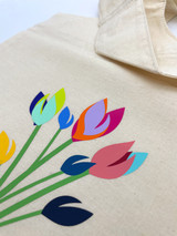 Closeup image of a linen bag and logo of “Tulips” using multiple colors of EasyWeed EcoStretch layered on top of each other.