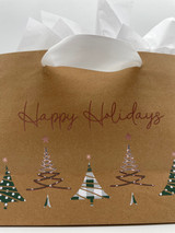 Closeup of a brown gift bag with the logo of “Happy Holidays” and “Five Christmas Trees” aligned across the bottom of the bag using the Sage Buffalo Plaid and Polka Dot Pattern alternately with splashes of Rose Gold EasyWeed Electric.