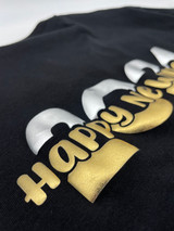 Black shirt with a logo that reads "Happy New Year" in Gold Puff Metallic Heat Transfer Vinyl over a larger font "2024" with the top portion Silver Puff Metallic Heat Transfer material and the bottom Gold Puff Metallic Heat Transfer Vinyl.