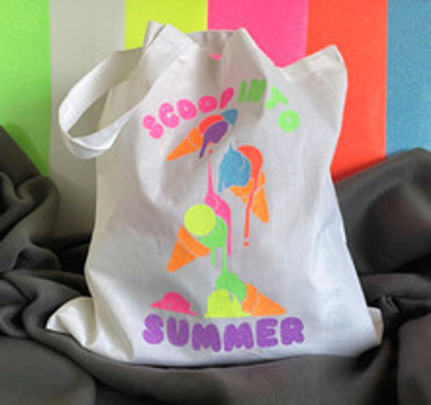 image of a white cotton bag and the logo of “Dripping Stacked Ice Cream Cones” and the words “Scoop In To Summer” surrounding them using Neon Pink, Orange, Yellow, Green, Blue Grapefruit and Purple.