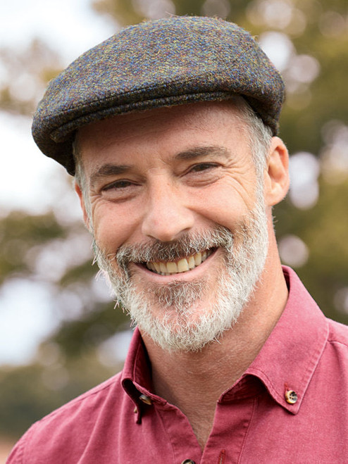 Model wearing Green Harris Tweed Flat Top Cap