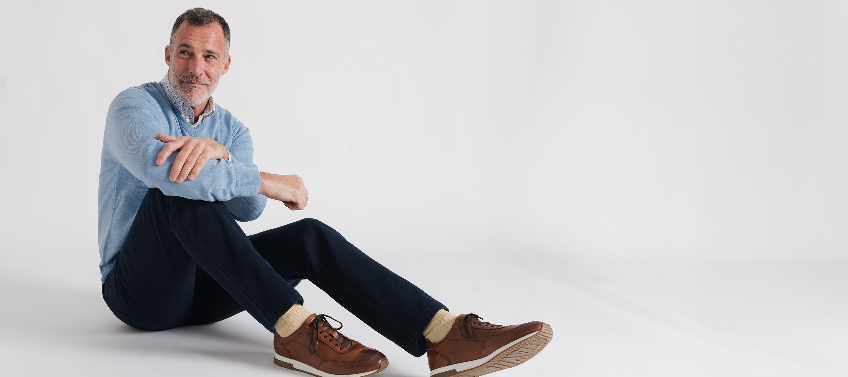 Happy casual young woman in yellow shirt, jeans and red sneakers