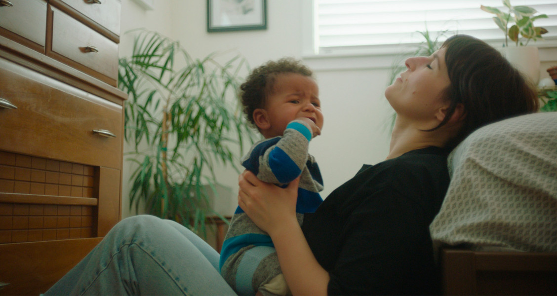 A crying baby with an exasperated mother