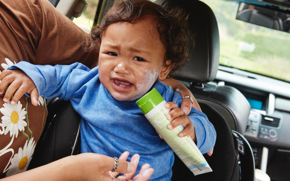 Man applying sunscreen to his child