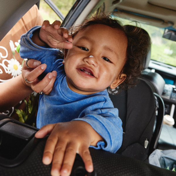 A young girl eating crackers outside