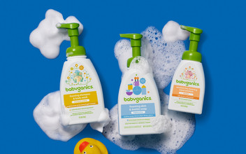 Image of a bottle of foaming shampoo & body wash, foaming dish & bottle soap, and alcohol free foaming hand sanitizer on a blue background with suds and a rubber duck