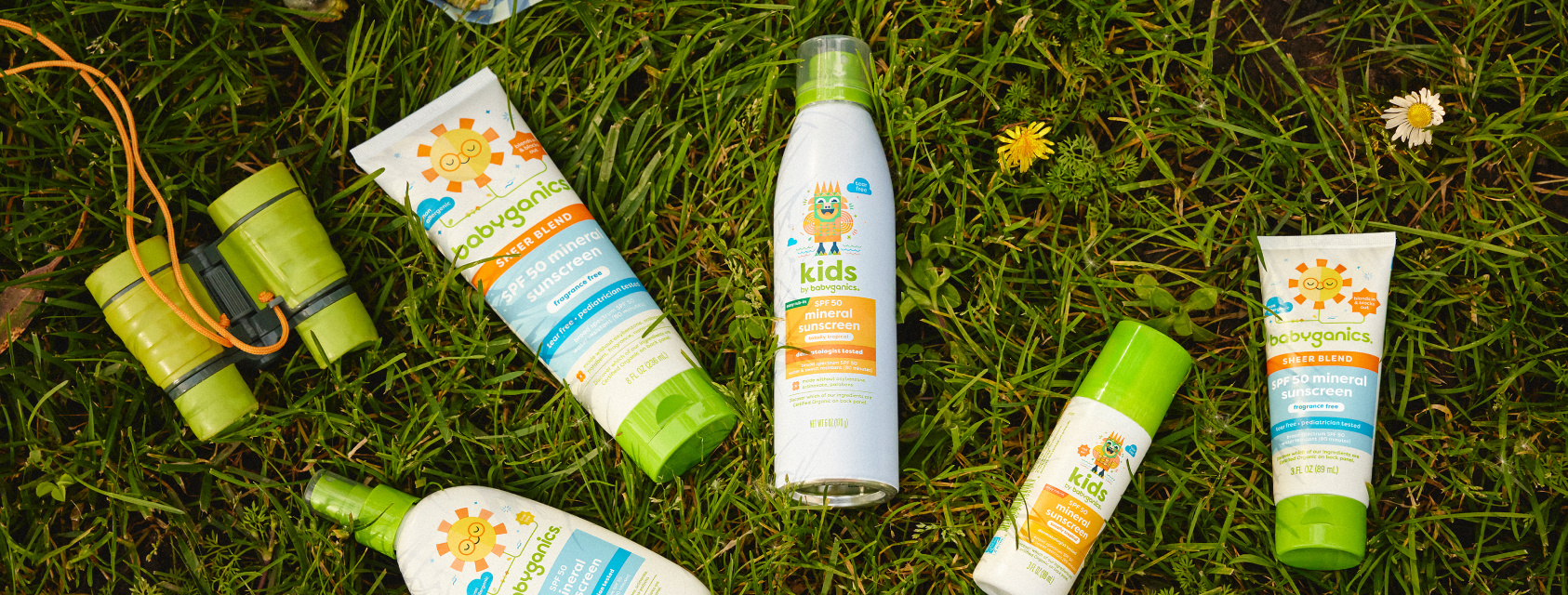 A man applying roller sunscreen to his daughter's face