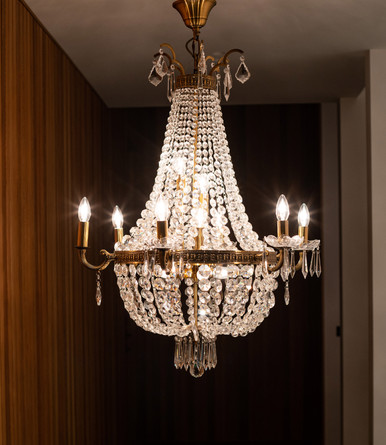 Antique brass twelve light pendant paired with crystal droplets