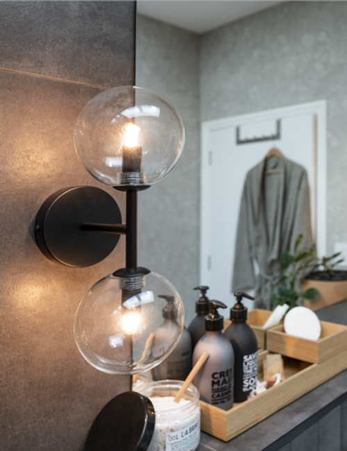 Black wall light with two clear globes