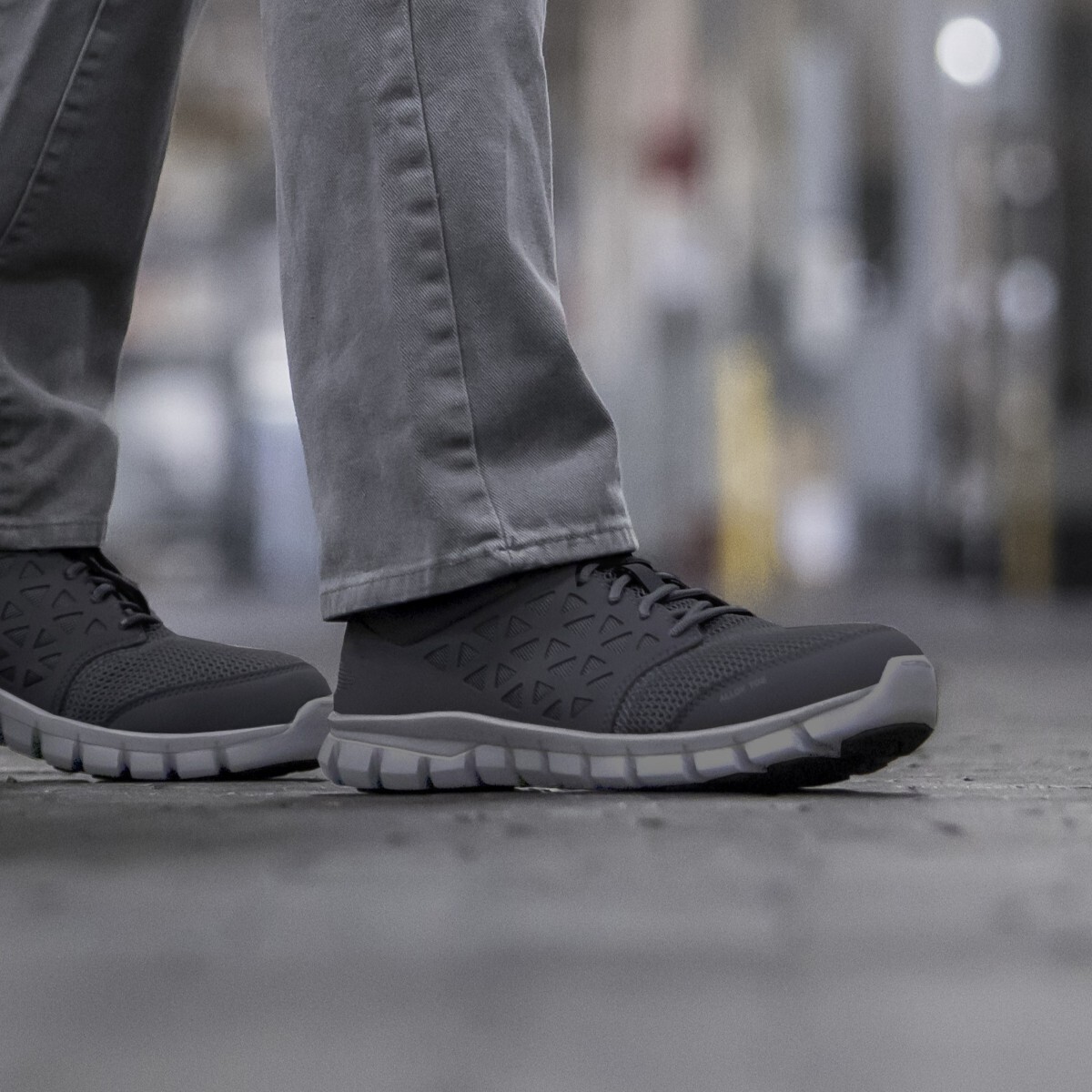 Close up of worker walking while wearing electrician approved work shoes.