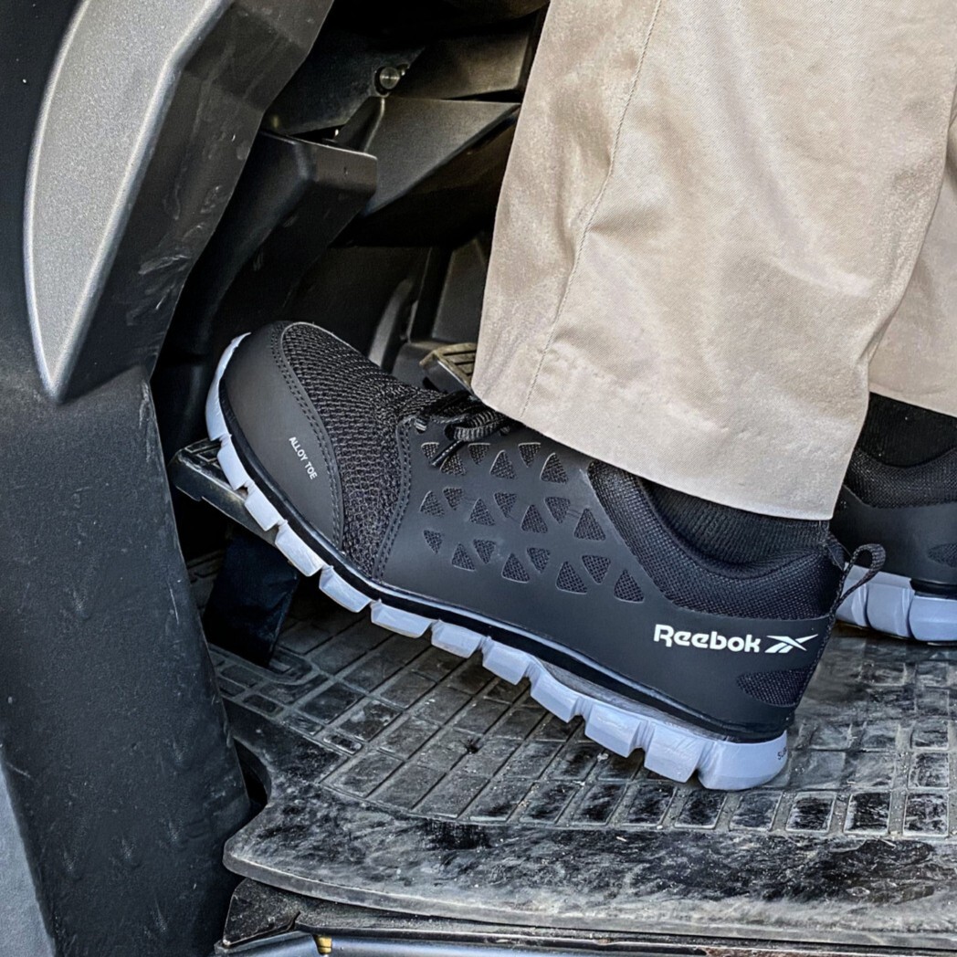 rb4041-lifestyle-img-0753-square.jpg Closeup shot of men's delivery driver shoe inside a car on the foot pedals.