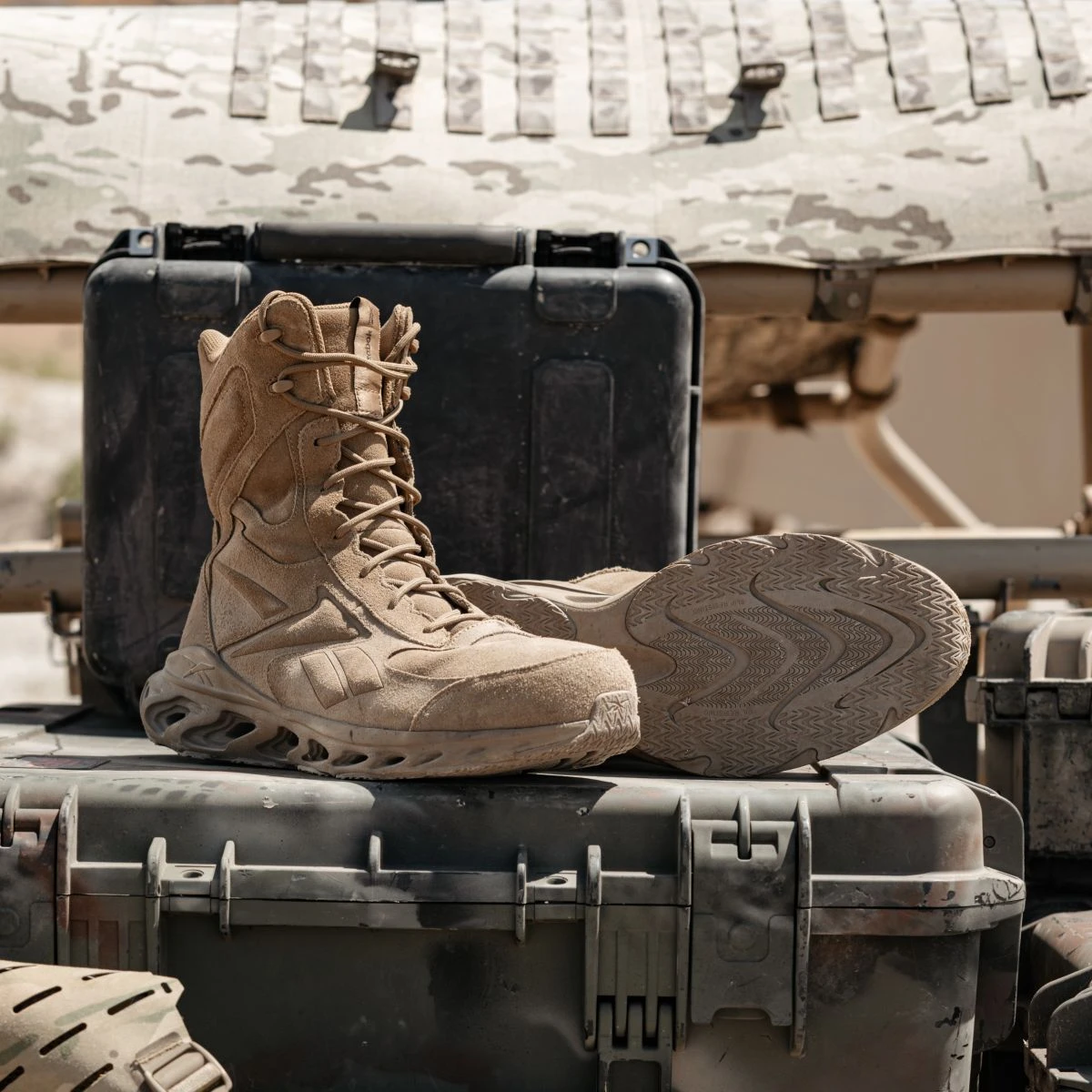 RB5480 men's tactical boots sitting in the back of a camouflaged military vehicle.