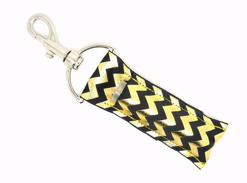 Midnight Luxe Black & Gold Chevron Lip Balm Holder ~ Lippy Clip Keychain

Turn everyday essentials into a statement with Midnight Luxe—a sleek and stylish lip balm holder featuring a deep black background with dazzling gold foil chevron stripes. Sophisticated and bold, this eye-catching piece adds effortless glam to your keys, purse, or backpack.

Perfect for evenings out, elegant gifting, or simply treating yourself to something chic and practical.

Why You’ll Love It:


Elegant black with radiant gold foil chevron design

Holds standard lip balms, chapstick, and more

Durable silver lobster clasp clips easily to keys, bags, or backpacks

Handmade from high-quality printed fabric

An ideal gift for glam lovers, coworkers, or yourself

Product Details:

Design: Black background with shiny gold foil chevron pattern

Material: High-quality printed fabric

Clip: Silver lobster clasp

Fits: Standard lip balm tubes (not included)

Includes: 1 Midnight Luxe lip balm holder

Handmade by Gettin Lippy in the USA
