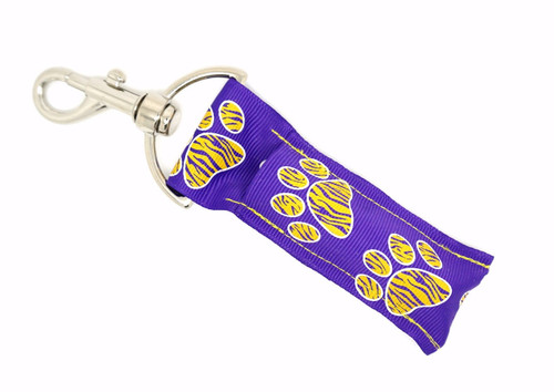 Lip Balm Holder Purple with Yellow Zebra Paw Prints

Purple with Yellow Zebra Paw Prints lip balm holder! This beautiful Lip Balm or Chapstick Holder is HANDMADE with a high-quality materials! Our unique design and clasp offer both style and functionality. The hook is on a swivel head so the lip balm always falls back down and never gets stuck upside down, this is where most lip balm holders lose your lip balm or chapstick! This lip balm holder is designed to snuggly fit any standard lip balm or chapstick. Make sure your lip balm or chapstick will not get lost and grab one of these! 

BENEFITS: Misplacing or Losing your lip balm or chapstick is the worst!! Don’t let that happen again and buy the perfect solution! Our Lip Balm / Chapstick Holder Keychain will make sure you always have your Gettin Lippy lip balm at hand when desperately needed. Our cute fun designs will compliment anything. Attach it to your keys, lanyard, back-pack, bag, purse, or anywhere your little heart desires with our easy open clasp!  

PERFECT GIFTS: A simple gift can go a long way. Everyone needs something cute and functional. Buy now for stocking stuffers, birthday party, a team gift or for a daughter, friend, wife, girlfriend, colleague, student, teacher, etc! 

BUY WITH CONFIDENCE: Read the reviews! Our Gettin Lippy Lip balm holders are the number one rated lip balm holders on the market! If you don’t LOVE our product, we offer 100% Money Back GUARANTEE no questions asked. 

PACKAGE INCLUDES:  1 Unique Lip Balm / Chapstick holder. Each Holder is 6.5 inches (with hook) x 1.5 inches. **NOTE: Gettin Lippy lip balms in pictures are not included but click on the link below and get the best multi-flavored lip balm on the market: https://gettinlippy.com/lip-balms-collegiate-line/uni-panthers-lip-balm/  

HANDMADE IN THE USA!!