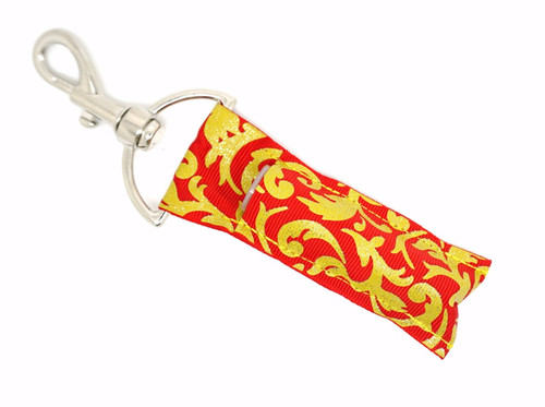 Lip Balm Holder Red with Gold Glitter Damask

Red with Gold Glitter Damask lip balm holder! This beautiful Lip Balm or Chapstick Holder is HANDMADE with a high-quality materials! Our unique design and clasp offer both style and functionality. The hook is on a swivel head so the lip balm always falls back down and never gets stuck upside down, this is where most lip balm holders lose your lip balm or chapstick! This lip balm holder is designed to snuggly fit any standard lip balm or chapstick. Make sure your lip balm or chapstick will not get lost and grab one of these! 

BENEFITS: Misplacing or Losing your lip balm or chapstick is the worst!! Don’t let that happen again and buy the perfect solution! Our Lip Balm / Chapstick Holder Keychain will make sure you always have your Gettin Lippy lip balm at hand when desperately needed. Our cute fun designs will compliment anything. Attach it to your keys, lanyard, back-pack, bag, purse, or anywhere your little heart desires with our easy open clasp! 

PERFECT GIFTS: A simple gift can go a long way. Everyone needs something cute and functional. Buy now for stocking stuffers, birthday party, a team gift or for a daughter, friend, wife, girlfriend, colleague, student, teacher, etc! 

BUY WITH CONFIDENCE: Read the reviews! Our Gettin Lippy Lip balm holders are the number one rated lip balm holders on the market! If you don’t LOVE our product, we offer 100% Money Back GUARANTEE no questions asked. 

PACKAGE INCLUDES:  1 Unique Lip Balm / Chapstick holder. Each Holder is 6.5 inches (with hook) x 1.5 inches. **NOTE: Gettin Lippy lip balms in pictures are not included but click on the link below and get the best multi-flavored lip balm on the market: https://gettinlippy.com/lip-balms-collegiate-line/iowa-state-cyclones-lip-balm/    

HANDMADE IN THE USA!! 