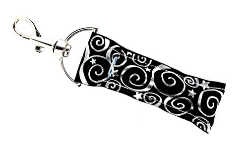 Lip Balm Holder Black with Silver Swirls

Black and silver foil swirls lip balm holder! This beautiful Lip Balm or Chapstick Holder is HANDMADE with a high-quality materials! Our unique design and clasp offer both style and functionality. The hook is on a swivel head so the lip balm always falls back down and never gets stuck upside down, this is where most lip balm holders lose your lip balm or chapstick! This lip balm holder is designed to snuggly fit any standard lip balm or chapstick. Make sure your lip balm or chapstick will not get lost and grab one of these! 

BENEFITS: Misplacing or Losing your chapstick is the worst!! Don’t let that happen again and buy the perfect solution! Our Lip Balm / Chapstick Holder Keychain will make sure you always have your Gettin Lippy lip balm at hand when desperately needed. Our cute fun designs will compliment anything. Attach it to your keys, lanyard, back-pack, bag, purse, or anywhere your little heart desires with our easy open clasp!

PERFECT GIFTS: A simple gift can go a long way. Everyone needs something cute and functional. Buy now for stocking stuffers, birthday party, a team gift or for a daughter, friend, wife, girlfriend, colleague, student, teacher, etc!

BUY WITH CONFIDENCE: Read the reviews! Our Gettin Lippy Lip balm holders are the number one rated lip balm holders on the market! If you don’t LOVE our product, we offer 100% Money Back GUARANTEE no questions asked.

PACKAGE INCLUDES:  1 Unique Lip Balm / Chapstick holder. Each Holder is 6.5 inches (with hook) x 1.5 inches. **NOTE: Gettin Lippy lip balms in pictures are not included but click on the link below and get the best multi-flavored lip balm on the market: https://gettinlippy.com/gettin-lippyoriginal-line/

HANDMADE IN THE USA!!
