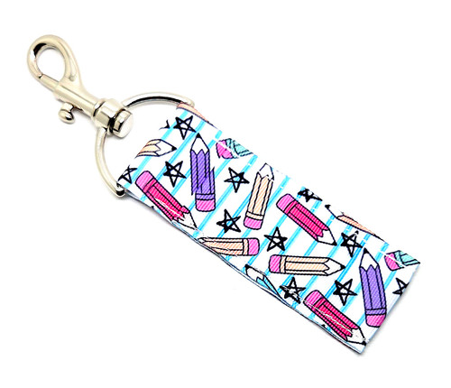 Too Cool for Drool – Teachers Lip Balm Holder

Whether they’re teaching ABCs or algebra, teachers deserve a little sass and self-care! Our “Too Cool for Drool” Teachers Lip Balm Holder keeps your balm close at hand — because dry lips just don’t make the lesson plan.

This adorable design features a white background with blue notebook-style lines, sprinkled with colorful pencils and playful stars, making it the cutest classroom companion ever. Clip it to your keys, lanyard, tote bag, or teacher badge, and you’ll never go searching for your favorite Gettin Lippy balm again!

Perfect for teachers who love staying organized and fabulous.

Why You’ll Love It

A+ Teacher-Inspired Design:
Colorful pencils and stars over a notebook paper background make this a straight-A accessory!

High-Quality Printed Fabric:
Soft, durable, and vibrant — made to last through every school year.

No More Lost Lip Balm or Chapstick:
Swivel clasp attaches easily to bags, badges, or lanyards for quick balm access between lessons.

Perfect Gift for Teachers:
Cute, functional, and full of personality — an ideal choice for Teacher Appreciation Week, end-of-year gifts, or back-to-school surprises.

Handmade in the USA:
Crafted with care and creativity — just like your favorite teachers!

Perfect For:

Teachers, aides, and school staff

Back-to-school or appreciation gifts

Cute, practical classroom accessories

Anyone who loves fun + functional gifts

Product Details

Dimensions: 6.5 inches (with hook) x 1.5 inches

Includes: 1 Lip Balm Holder (lip balm not included)

Material: High-quality printed fabric

Handmade in the USA

Pair it with your favorite Gettin Lippy lip balm, keychain wristlet, or body care favorite for the ultimate teacher-approved combo.