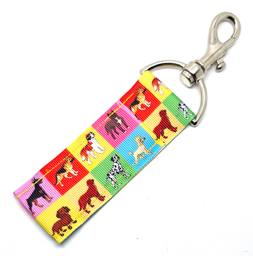 Paws on the Big Screen – Retro Dog Squares Lip Balm Holder

Lights, camera… wag!
Your lip balm is officially ready for its close-up with the Paws on the Big Screen Lip Balm Holder — a retro-fun accessory that brings total dog-lover energy to your everyday carry.

Featuring a vibrant grid of bright, multicolored squares — each one showcasing an adorable dog — this design feels like Hollywood Squares, but make it puppy edition. From bold blues and sunny yellows to hot pinks, greens, purples, and oranges, every square pops with personality (just like the pups they represent!).

Clip it on your keys, purse, backpack, or dog-walking bag for a cheerful burst of color and canine charm. It’s the perfect blend of playful, practical, and paw-sitively irresistible.

Why You’ll Love It

Retro Doggie Squares Design – Bright, bold, and totally unique — every square features a cute dog face

Perfect for Dog Lovers – Great for dog moms, pet sitters, veterinarians, groomers, walkers, and anyone who swoons over pups

Easy Access – No more losing your chapstick in the bottom of your bag

Vibrant & Fun – Adds a pop of color and personality wherever you clip it

Product Details

Size: Approx. 6.5" x 1.5"

Material: High-quality printed fabric

Includes: 1 Paws on the Big Screen lip balm holder (lip balm not included)

Handcrafted in the USA