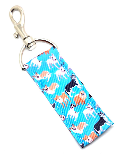Sky’s the Limit – Blue Pup Parade Lip Balm Holder

If you believe there’s no such thing as too many dogs, the Sky’s the Limit Lip Balm Holder was made just for you!

This adorable holder features a beautiful sky-blue background sprinkled with all kinds of different dogs — big dogs, tiny dogs, fluffy dogs, goofy dogs… basically a whole cheerful parade of pups ready to brighten your day.

It’s the perfect combination of cute, colorful, and crazy convenient. Clip it to your keys, purse, backpack, lanyard, or dog-walking bag and keep your lip balm close, secure, and always easy to find.

Why You’ll Love It

Blue Pup Parade Design – A sky-blue backdrop filled with a diverse mix of adorable doggies

Ideal for Every Dog Lover – Perfect for dog moms, dog dads, groomers, walkers, and pup-obsessed humans

No More Lost Lip Balm – Swivel clasp keeps your chapstick in place and accessible

Cute + Durable – A bright, happy accessory that holds up to daily use

Product Details

Size: Approx. 6.5" x 1.5"

Material: High-quality printed fabric

Includes: 1 Sky’s the Limit lip balm holder (lip balm not included)

Handcrafted in the USA